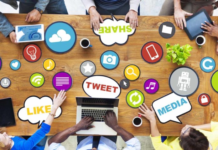 Global communication group works at a table